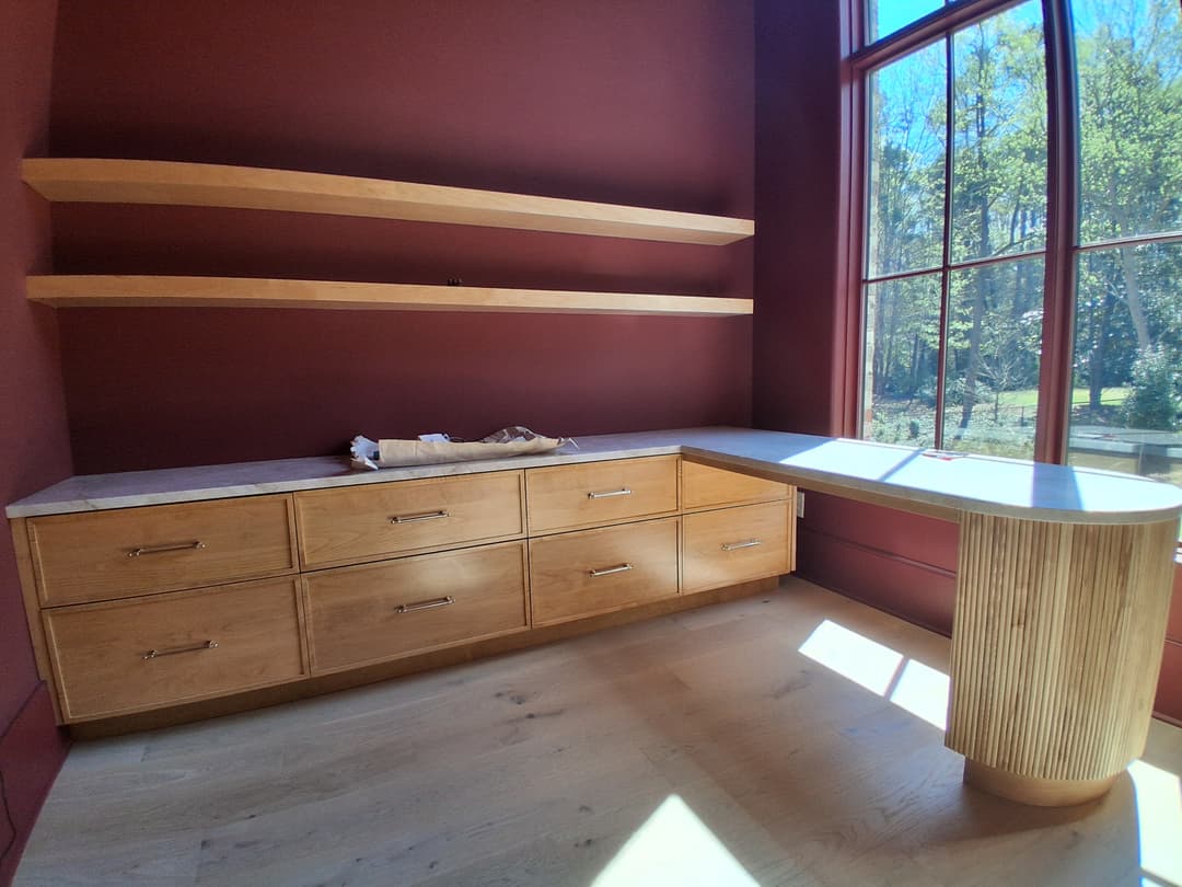 Custom built-in fluted desk cabinetry painted burgundy by Hdez Gabinets